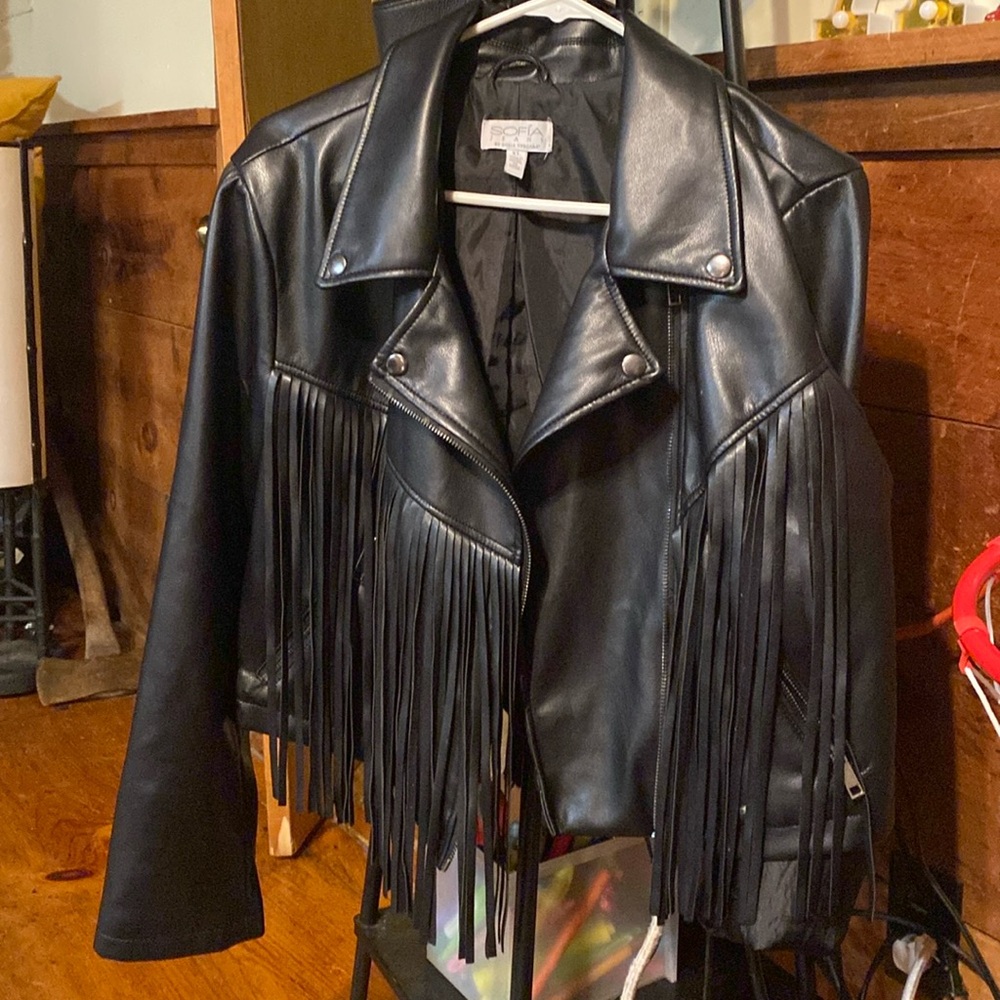 Black leather coat with black fringe around it